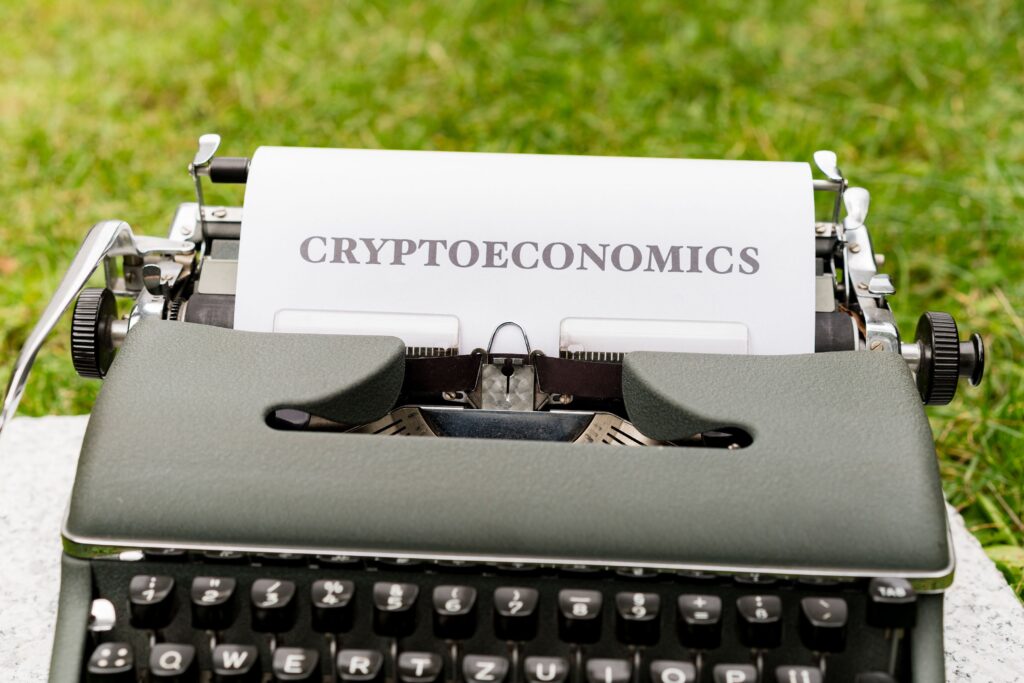 A typewriter with the word cryptonomics on it by Markus Winkler