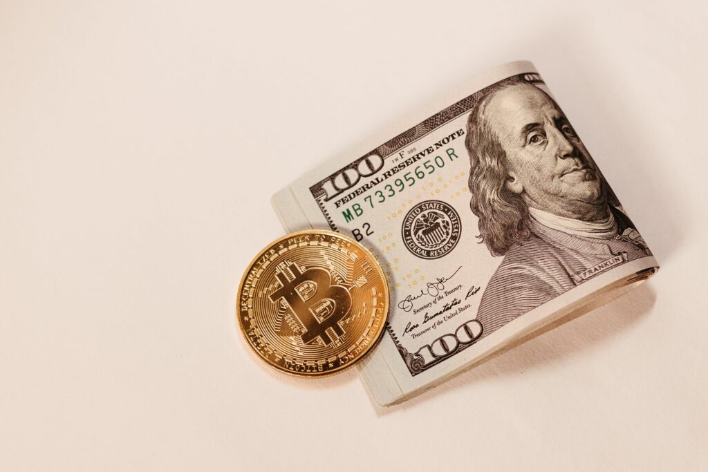 Gold Bitcoin Coin and Cash  by Jonathan Borba