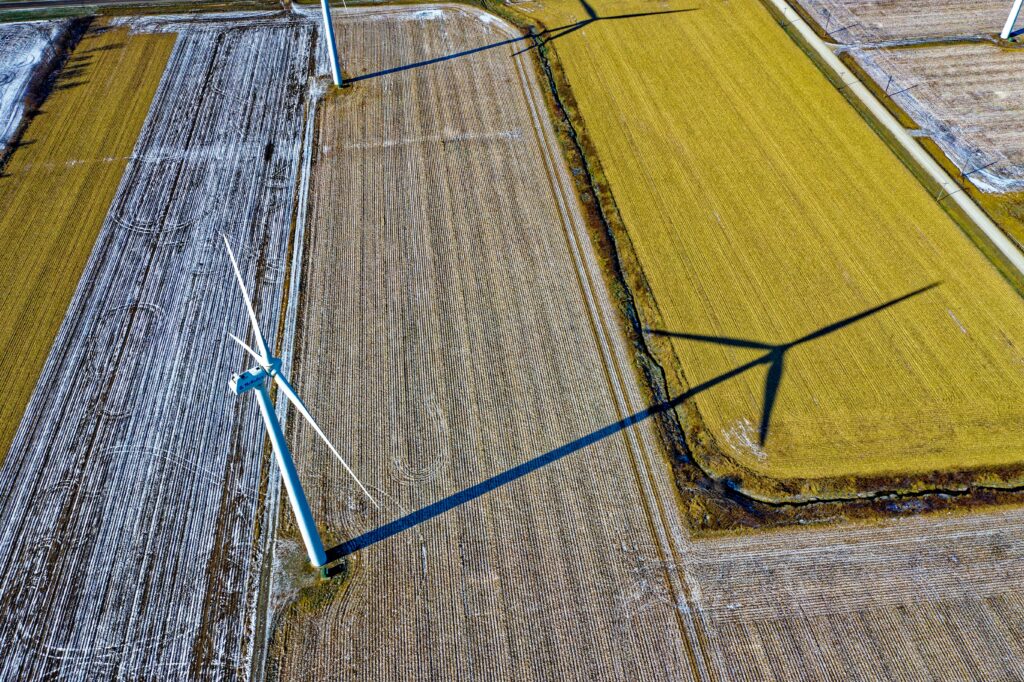 High Angle Photo of Wind Turbine on Field by Tom Fisk