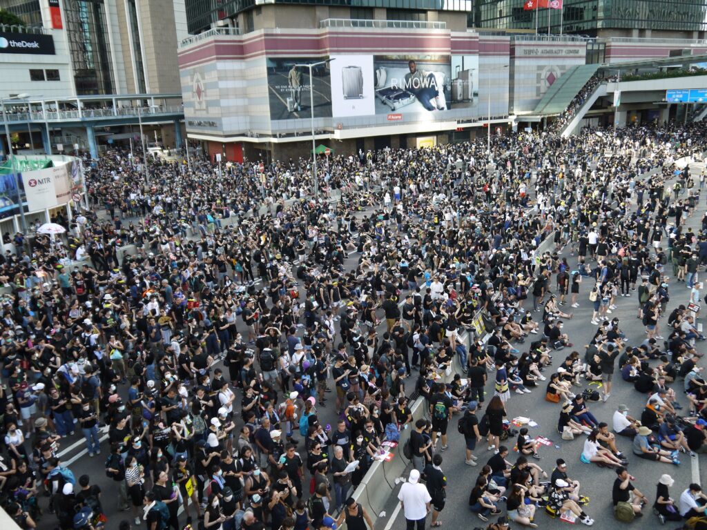 High angle of crowded street of city downtown gathered together to defend and resist Government by LT Chan