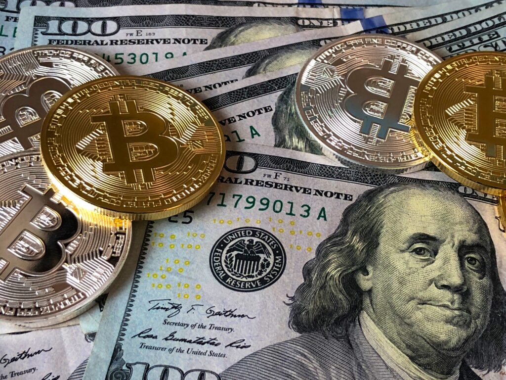 Bitcoins and U.s Dollar Bills by David McBee