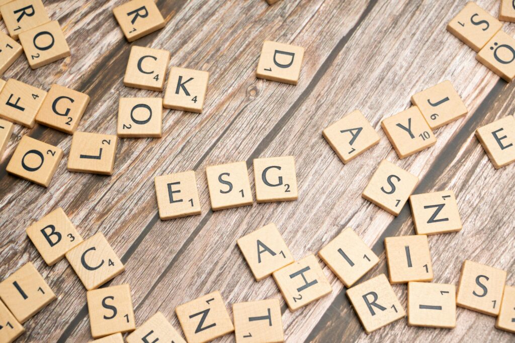 Scrabble tiles on a wooden table with the word rock by Markus Winkler