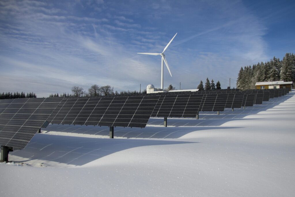 Solar Panels on Snow With Windmill Under Clear Day Sky by Pixabay
