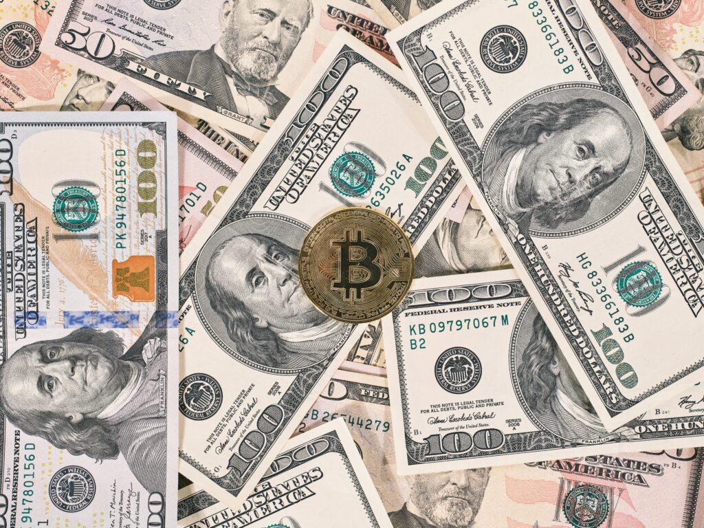 Bitcoin on American dollar banknote close up by Engin Akyurt