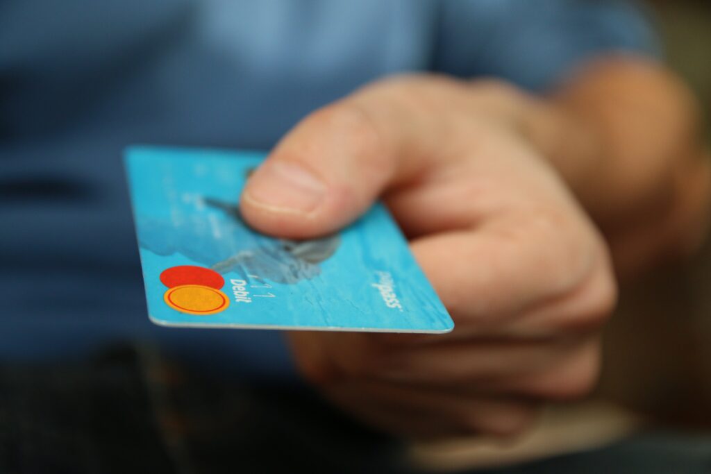 Person Holding Debit Card by Pixabay