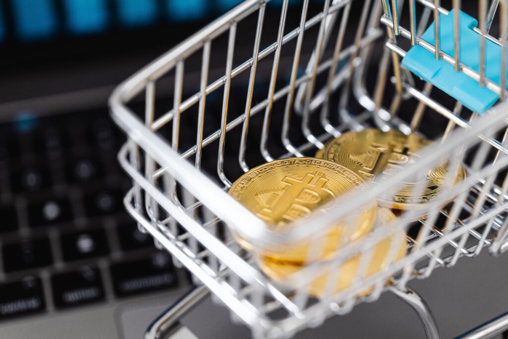Gold Bitcoin Coins in a Miniature Shopping Cart  by Karolina Grabowska