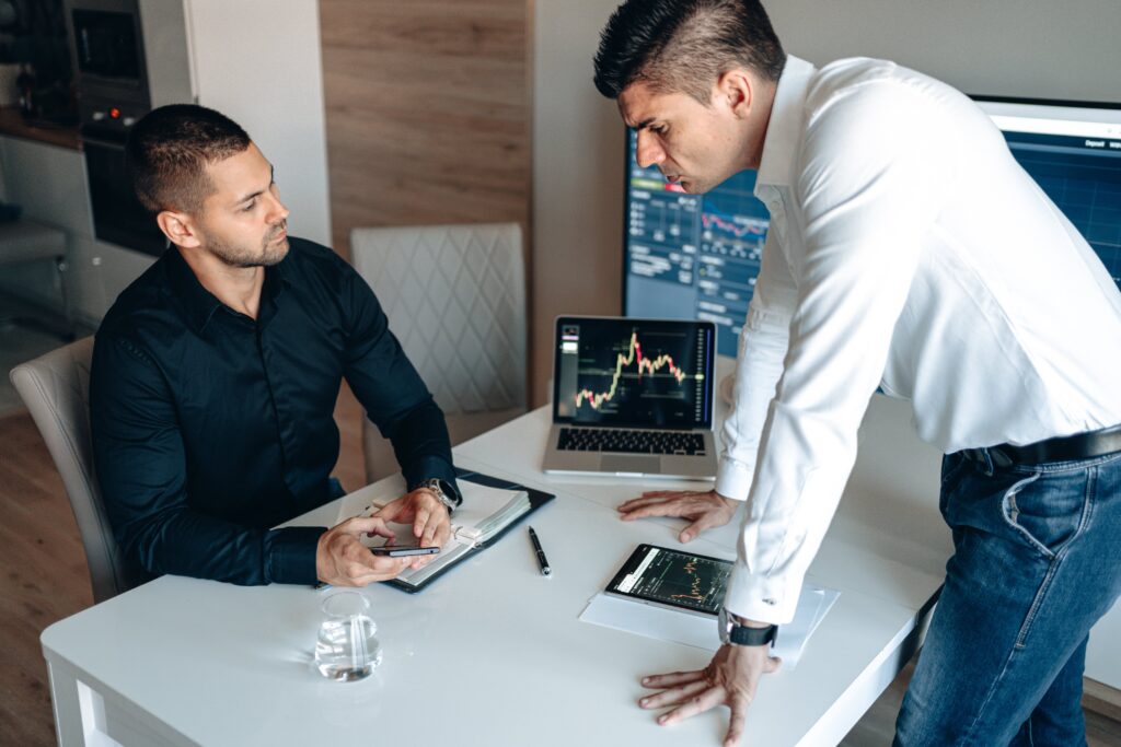 Men Checking Data on Stock Market by AlphaTradeZone