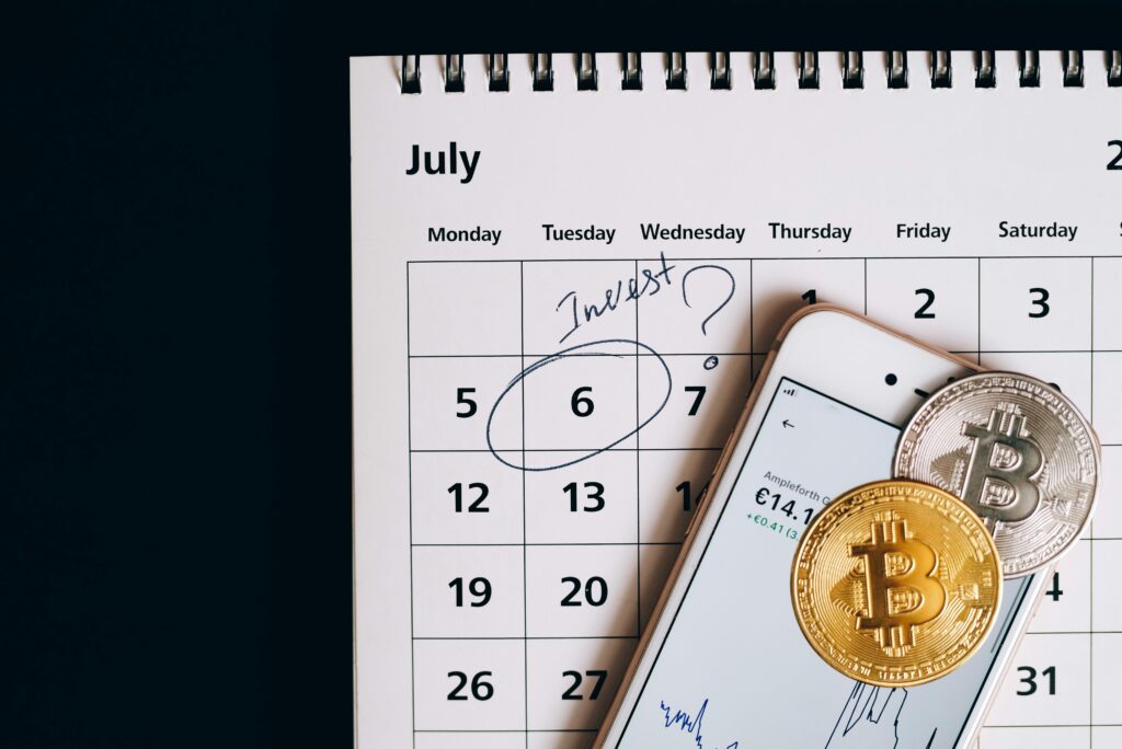 Bitcoins on Smartphone Lying on Calendar by Leeloo The First