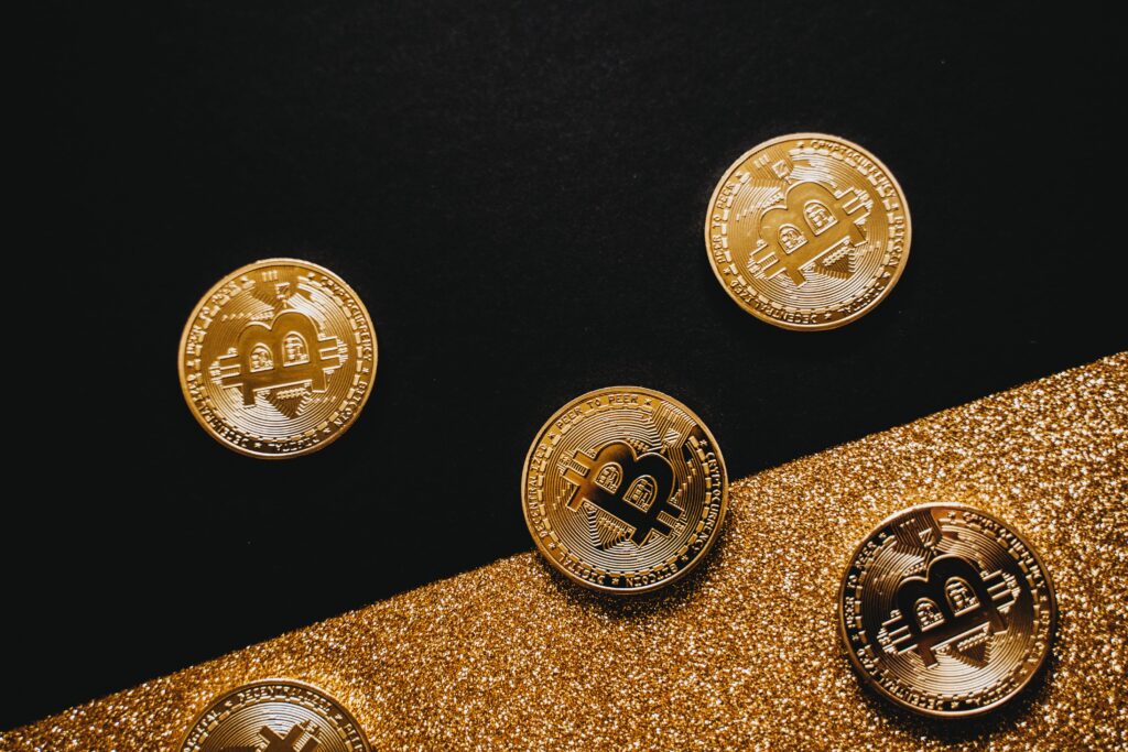 Gold Bitcoins on Black Surface by Alesia  Kozik