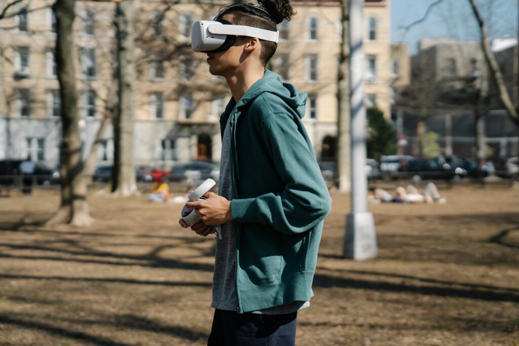 Young man walking with VR goggles by Eren Li