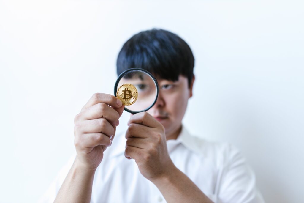 A Man Looking at a Coin Through a Magnifying Glass by RDNE Stock project