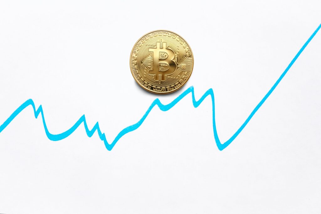 Gold bitcoin cryptocurrency coin and blue graph of changes of value on white background by Ivan Babydov