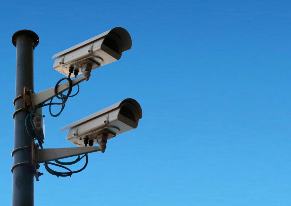 Surveillance cameras against blue sky by Atypeek Dgn
