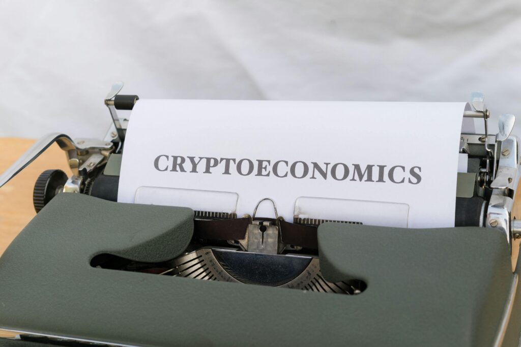 A typewriter with a paper that says cryptonomics by Markus Winkler