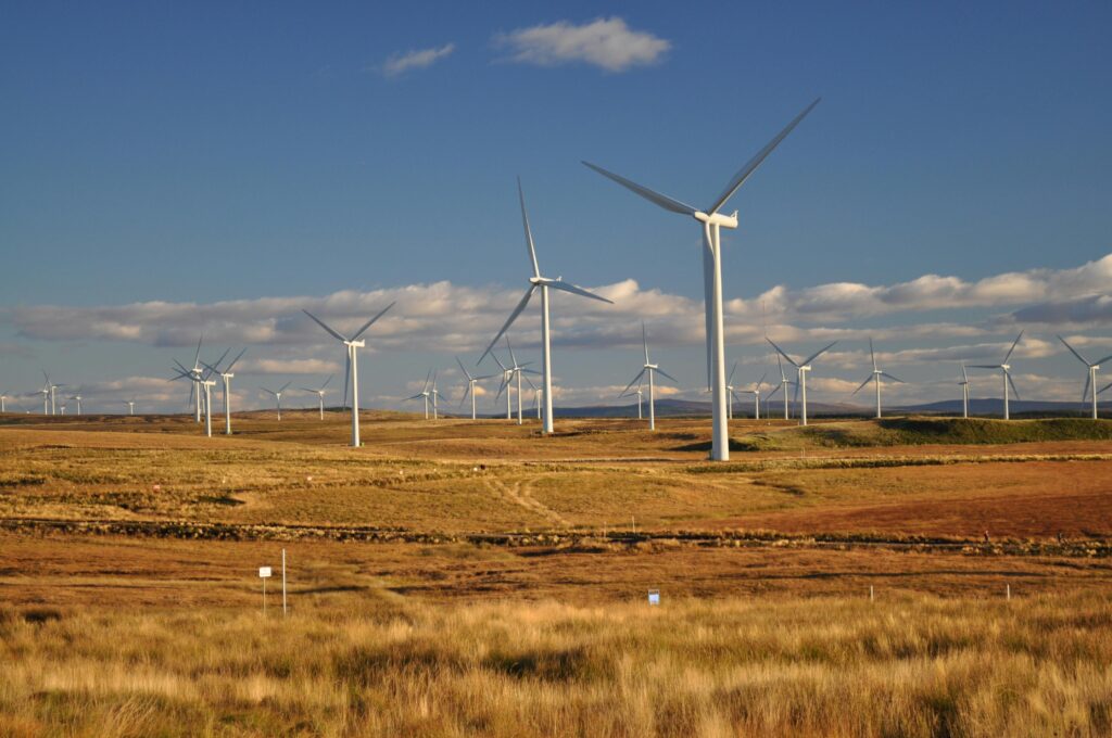 Photograph of White Windmills Under a Blue Sky by Peechie247