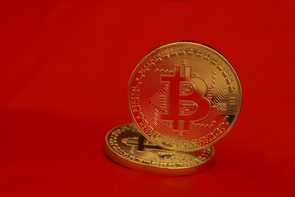 Gold Round Coin on Red Background by Daniel Dan