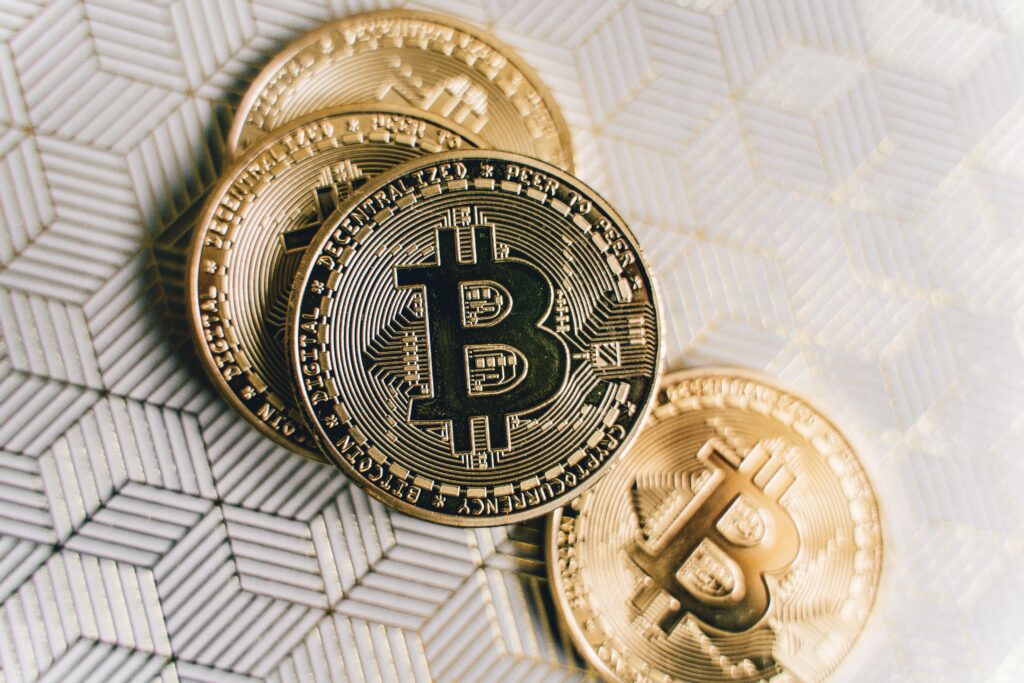Close Up Photo of Four Bitcoins by Alesia  Kozik
