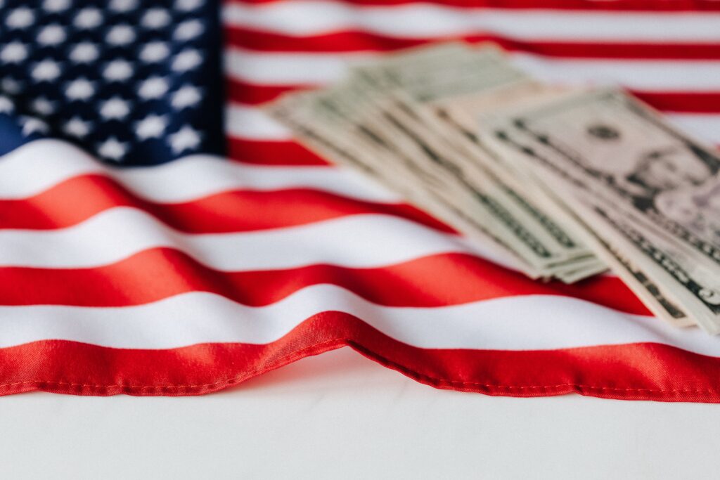 American dollars on national flag by Karolina Grabowska