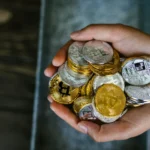 Hands holding cryptocurrency coins image