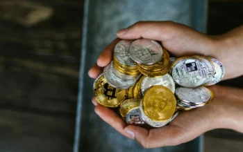 Hands holding cryptocurrency coins image