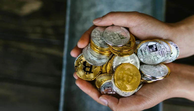 Hands holding cryptocurrency coins image