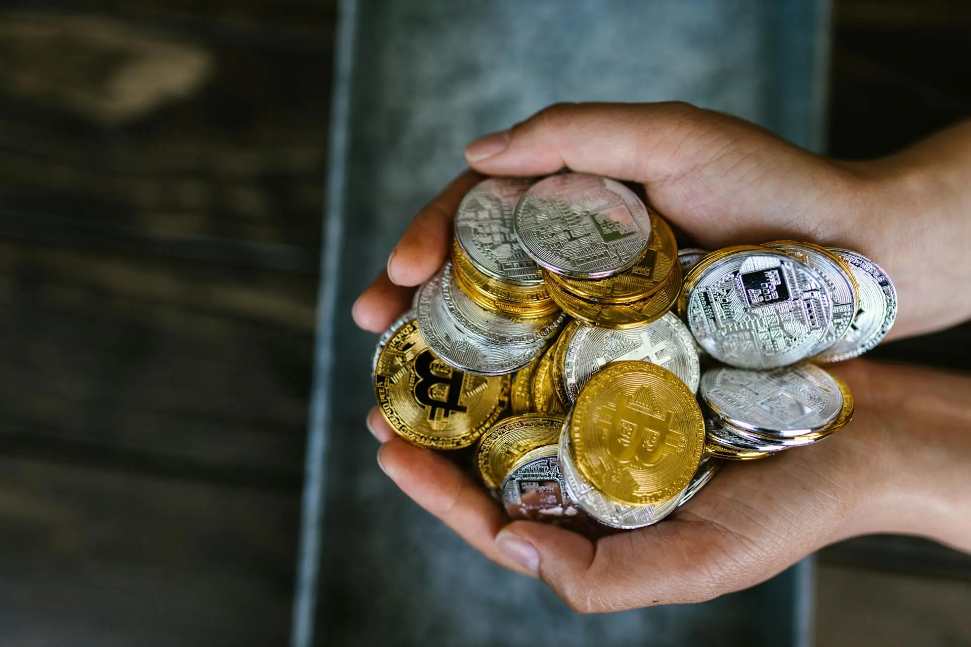 Hands holding cryptocurrency coins image